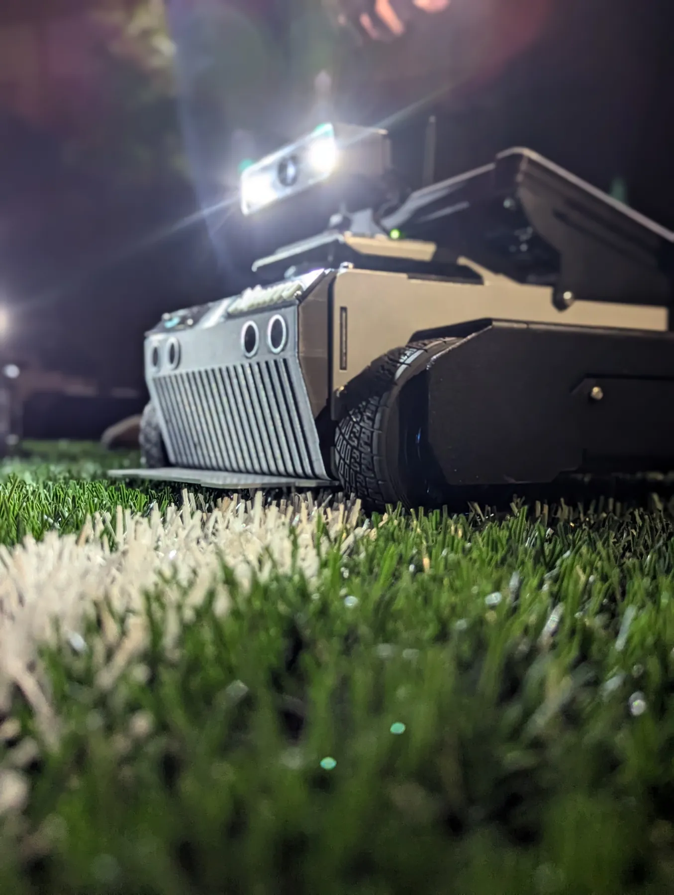 ARJUNA with its headlight on, on turf at night